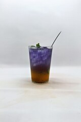 Refreshing Indonesian drink made with passion fruit and butterfly pea flower, Es Markisa Bunga Telang. Naturally vibrant with a sweet and tangy flavor, served cold with ice.