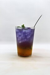 Refreshing Indonesian drink made with passion fruit and butterfly pea flower, Es Markisa Bunga Telang. Naturally vibrant with a sweet and tangy flavor, served cold with ice.