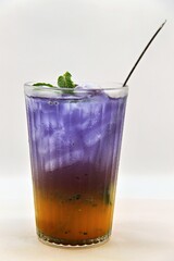 Refreshing Indonesian drink made with passion fruit and butterfly pea flower, Es Markisa Bunga Telang. Naturally vibrant with a sweet and tangy flavor, served cold with ice.