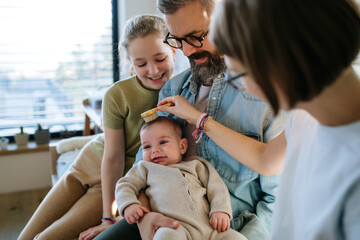 Older sisters helping with little baby brother.