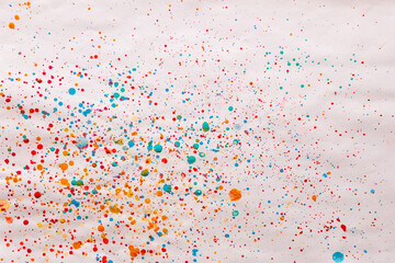 Colored droplets splatters and spots made by child using watercolor painting