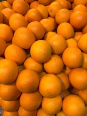 Fresh orange fruits with leaves as background top view