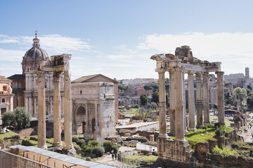 Roman forum ruins are reflecting the grandeur of ancient roman civilization under a clear blue sky, showcasing the historical significance and architectural marvels of this iconic landmark