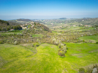Aerial image, taken by drone, of the hilly area of Oltrepo Pavese (Lombardy Region, Northern Italy), surrounding the village of nFortunago, one of the most beautiful villages of Italy.