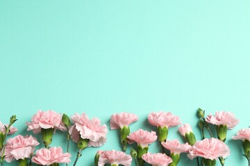 Beautiful bouquet of pink carnations on a color background
