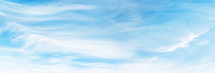 Majestic sunny sky with scattered small clouds