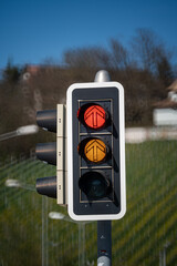 Urban traffic semaphore or stop light with illuminated red and orange lights. Looking up shot,...