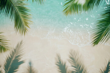 Overhead view of palm fronds framing turquoise water lapping sandy beach, creating a serene tropical scene ideal for summer or vacation themes