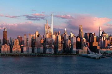 Aerial panoramic view of Upper West Side high-rise buildings and supertall skyscapers at dusk. Hudson River Park with Manhattan skyline. New York City