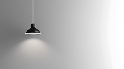 Minimalist black pendant lamp illuminating a white wall.