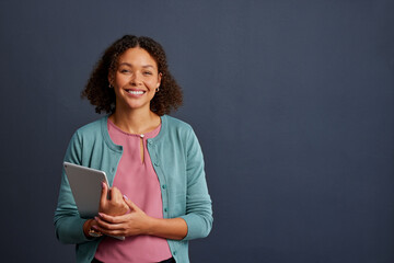 Smiling african american woman holding digital tablet