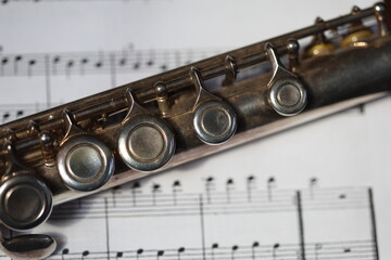 Naklejka premium A flute lying on a sheet of music