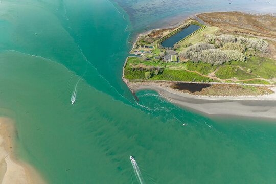 Mariano lagoon and spead boats near a Marinetta Island, Italy