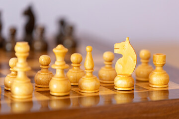 Wooden white chess pieces on the chessboard