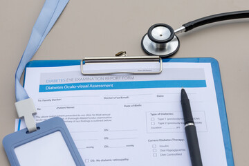 A clipboard holds a detailed aculo-visual screening sheet meant for diabetic diagnosis.