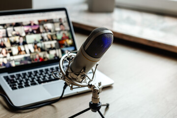 Radio broadcasting studio with podcast equipment: microphone and laptop
