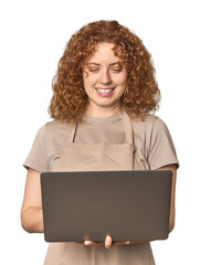 Young Caucasian redhead baker with laptop
