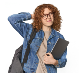 Young Caucasian redhead student with books touching back of head, thinking and making a choice.