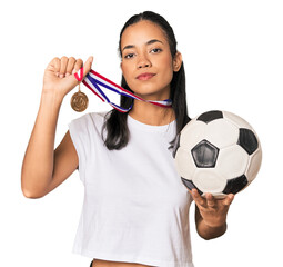 Young Filipino female with soccer ball and medal in studio
