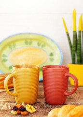 Steaming mugs inviting to a cozy and healthy breakfast