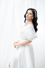 An elegant bride in a classic wedding gown. Her confident pose and graceful aura make this portrait...