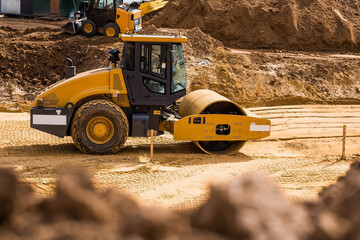 Heavy machinery for excavation and landscaping. Close-up of a road roller on a construction site in...