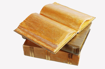 Open book and other old books on white.
