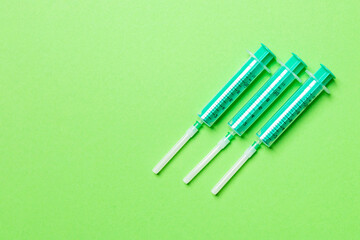 Top view of medical syringes on colorful background with copy space. Injection equipment concept