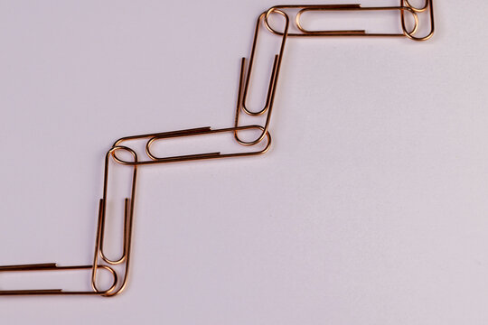 paper clips made of metal for the systematization of documents, The paper clips are stacked in the shape of a ladder