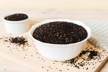quinoa seeds in bowl on colored background. Healthy kinwa in small bowl. Healthy superfood