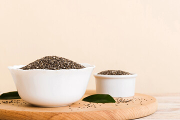 Chia seeds in bowl on colored background. Healthy Salvia hispanica in small bowl. Healthy superfood