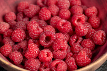 raspberries on the table, the collected amount of ripe raspberries is red closeup