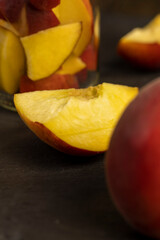 peaches cut into pieces on slate, ripe orange peaches cut into slices, close up