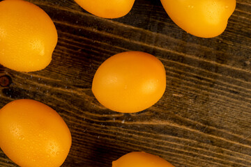 a large number of orange tomatoes that are on the table, whole clean washed orange tomatoes with...