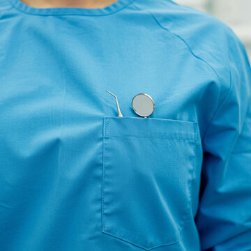 
Female dentist has tools in her pocket, close-up