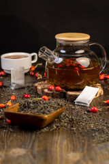 rosehip in red and green tea on the table during cooking closeup, side view