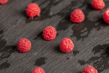 raspberries on the table, collected amount of ripe raspberries is red closeup