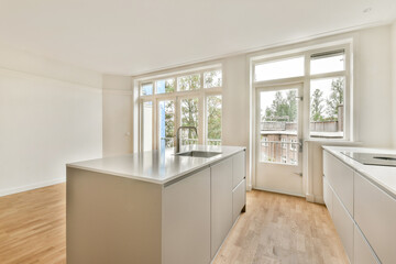 A stylish modern kitchen featuring sleek cabinetry and ample natural light, perfect for contemporary living spaces and culinary activities.