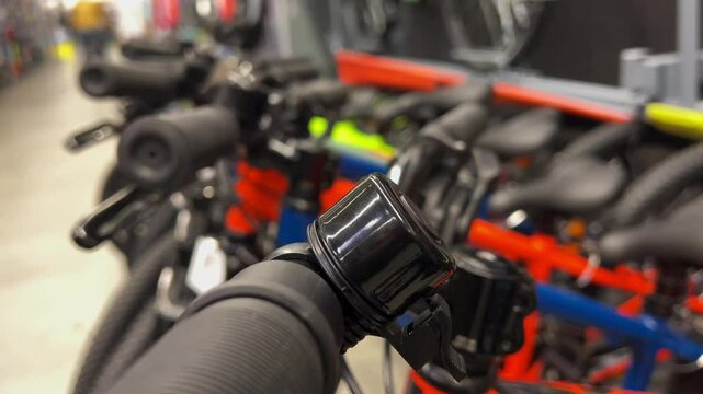 Closeup of bicycle handlebars with black bell in retail store
