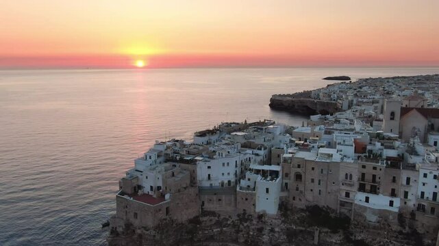 polignano a mare aerial shot drone at sunrise puglia,view of the famous village on the cliff facing the mediterranean sea