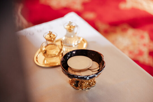 A close-up view of communion elements in a church, with bread and wine placed as sacred offerings. The scene reflects tradition, faith, and the spiritual meaning of the wedding ceremony.
