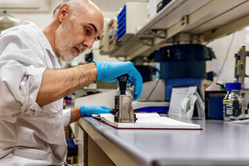 Naklejka premium Scientist using a stamp in a laboratory with selective focus in a clinical setting