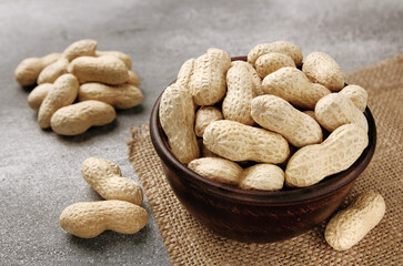 Organic Raw Peanuts in a Bowl on grey table