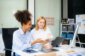Fototapeta premium Female discussing new project with male colleague. Young woman talking