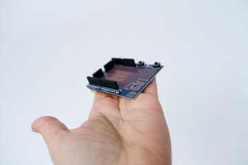 scientist, electronic engineer holds electronic chip, bug, microcontrollers in hand, Electronics...