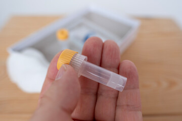 Hands holding blood collection vial and lancet, medical testing and diagnostics, Blood collection...