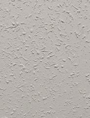 Neutral textured plaster wall surface with subtle stucco pattern, ideal for architectural backgrounds, construction themes, and minimalist interior design presentations
