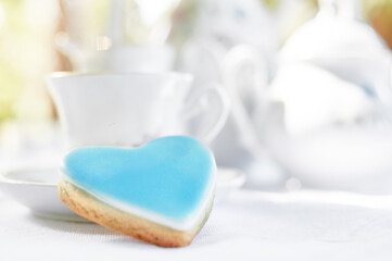 Blue Heart Cookie With Tea Set in Soft Natural Light..