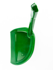 A green plastic dustpan with an ergonomic long handle, isolated against a white background. Ideal for waste collection, janitorial services, and household maintenance.