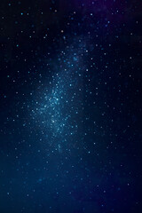 Dark cosmic sky illuminated by glowing blue galactic dust and stars